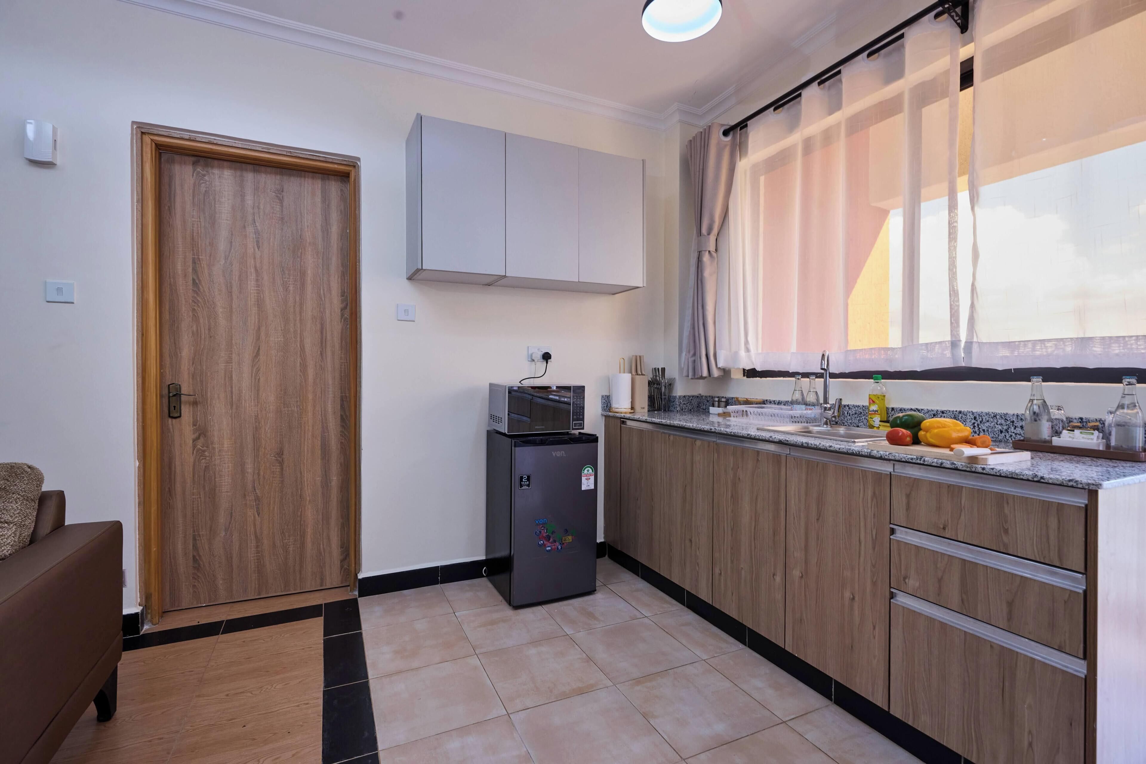 Departamento ejecutivo, 1 habitación | Cocina privada | Refrigerador, microondas, horno y parrilla de estufa 