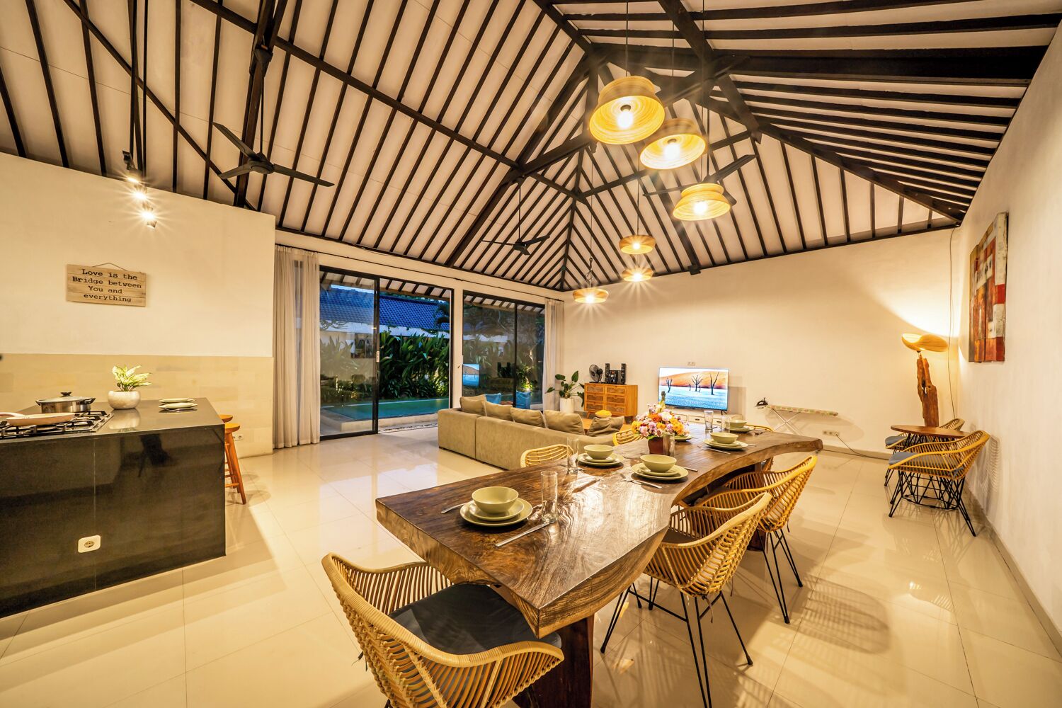 A spacious living area with a kitchen, dining table, and seating.