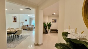 Een modern interieur met een eetgedeelte, een woonkamer en een gang naar een andere kamer.
