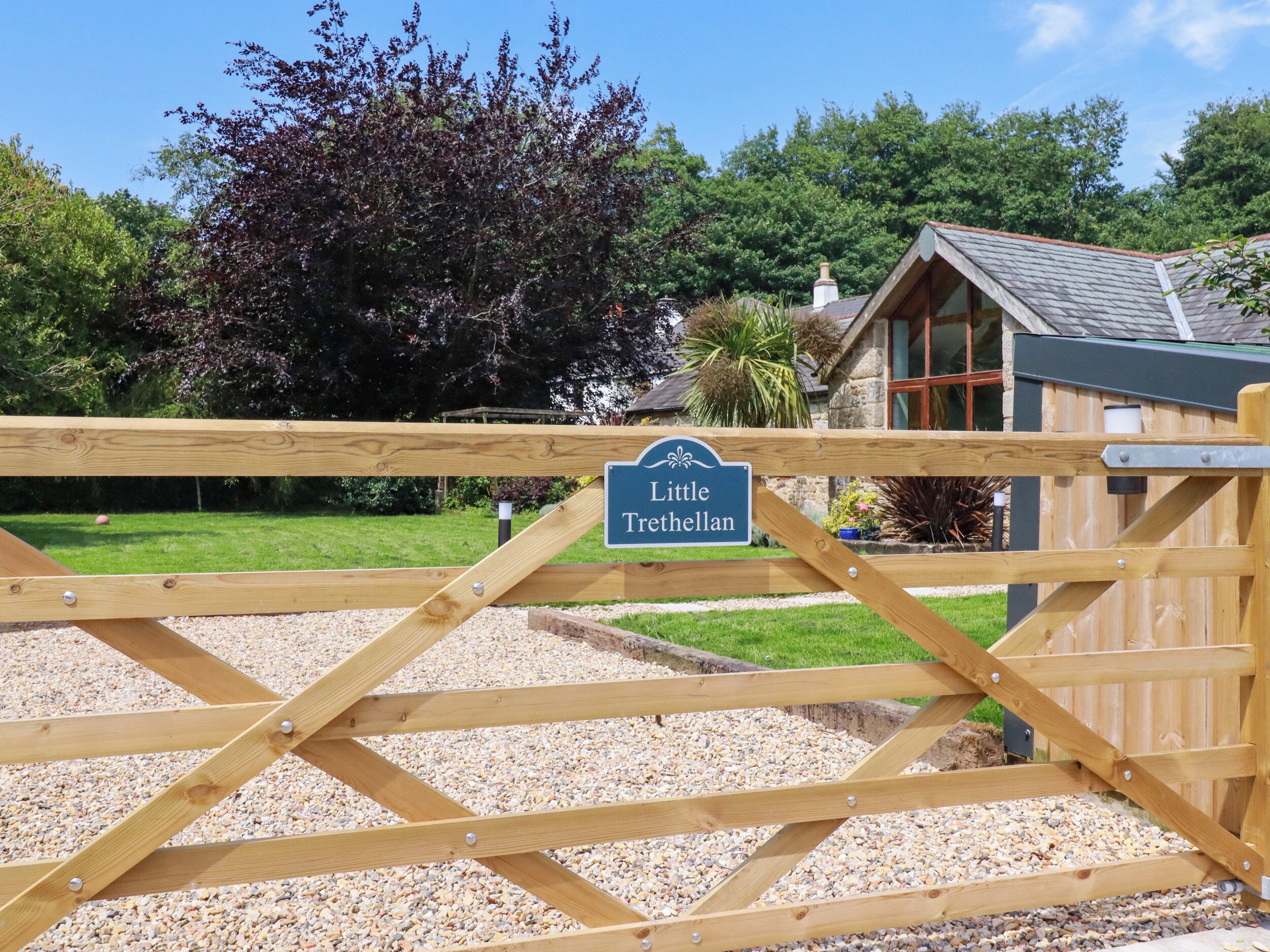 A wooden gate with a sign reading 'Little Trethelann.'