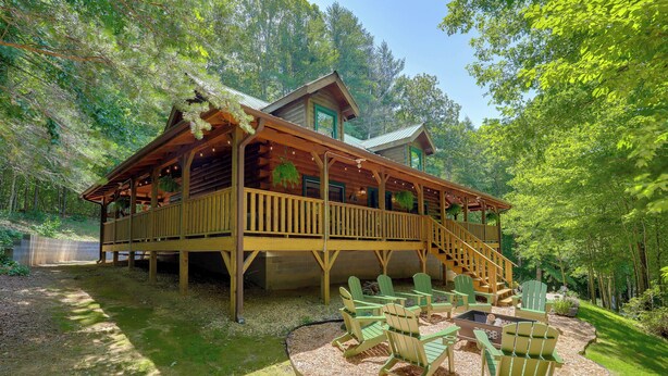 A cabin with a deck, outdoor seating, and a fire pit. - Marion Cabin w/ Wrap-Around Deck & Outdoor Kitchen (Marion)