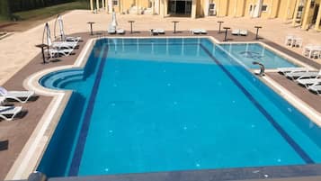 Seasonal outdoor pool, open 8:00 AM to 6:30 PM, pool umbrellas