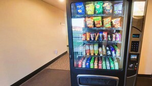 A vending machine with snacks and beverages.