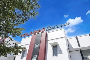 A building with a sign reading 'POLAMAS Residences.'