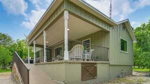 A two-story building with a porch, a covered deck, and a small attached shed. - Bring Your Boats! Waterfront Retreat on PK Lake (Graford)