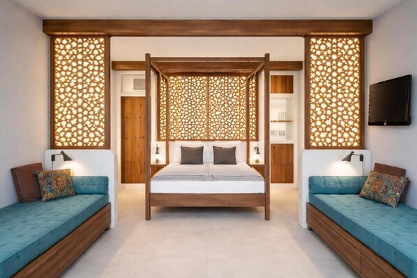 Un dormitorio con cama con dosel, dos mesitas de noche, televisor montado en la pared y un biombo de madera decorativo.