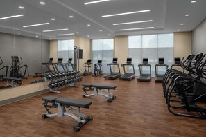 A gym with treadmills, weight benches, and dumbbells. - Residence Inn by Marriott Irving Las Colinas (Irving)