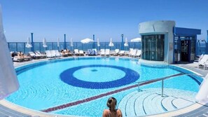 A pool with a circular design, lounge chairs, and a glass-enclosed structure. - Isrotel Tower by Sea N' Rent (Tel Aviv-Yafo)