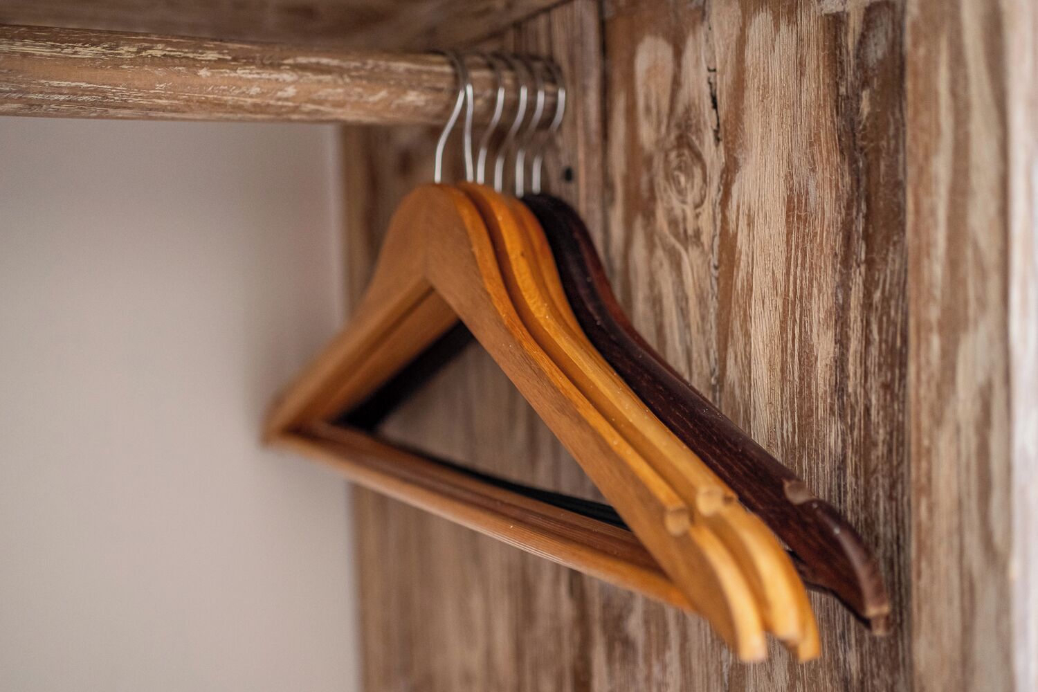 A wooden hanger with a triangular shape.