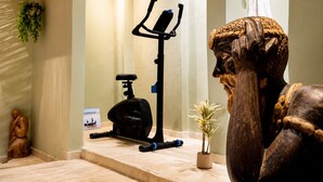 A bathroom with a wooden sculpture, a towel rack, and an exercise bike. - Private Spa & Charming Patio (Near Avignon & the Vineyards) (Roquemaure)