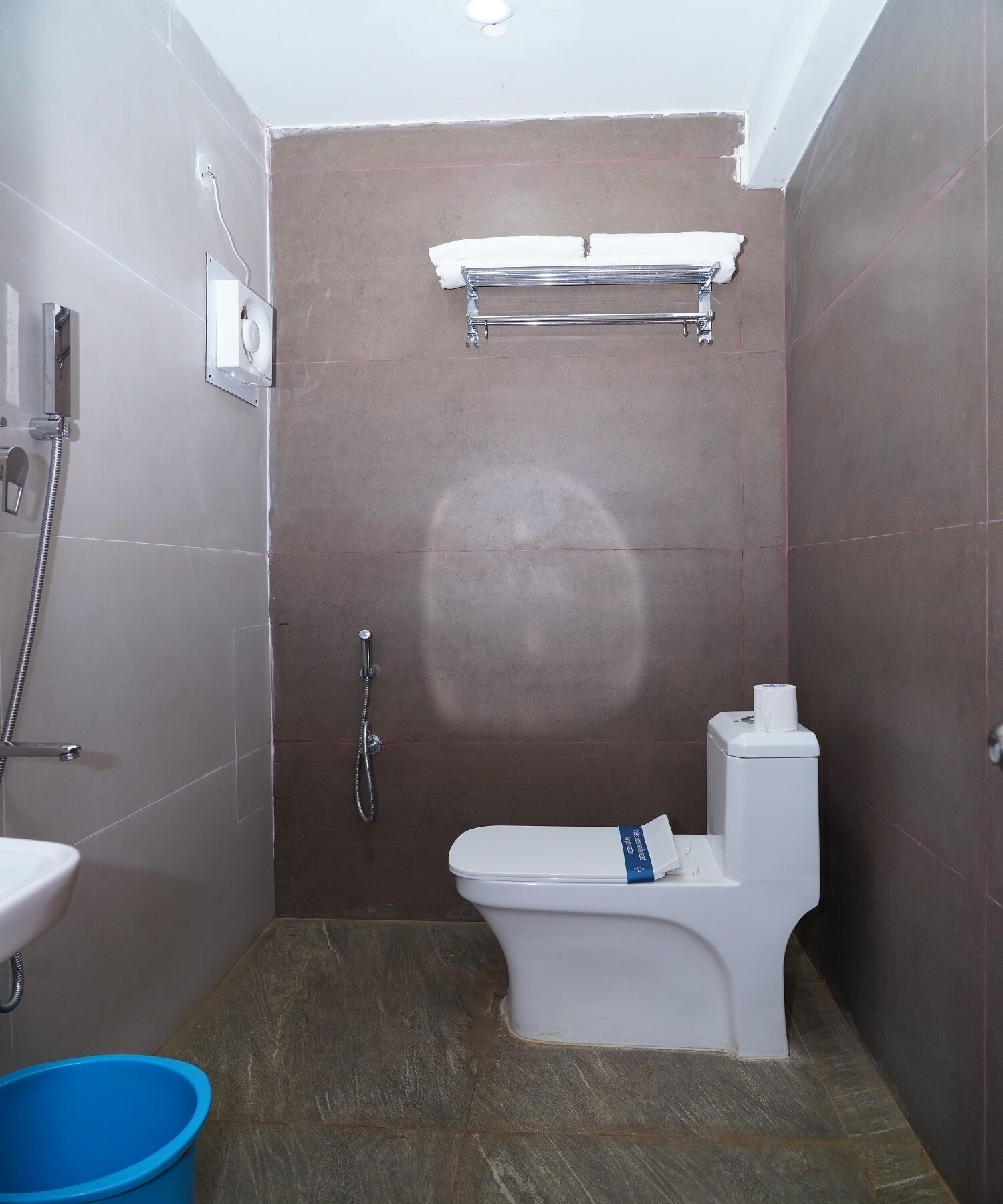 A bathroom with a shower, toilet, and sink.