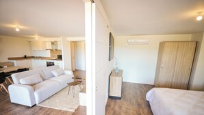 A modern interior with a sofa, a small table, a cabinet, and a wardrobe.
