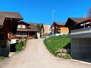 A residential street with houses, a clear sky, and a no-entry sign. - HasliRent, Wetterhornblick, (Hasliberg Reuti), by Interhome (Hasliberg)