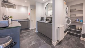 A modern kitchen with a built-in microwave, toaster, and a large island.