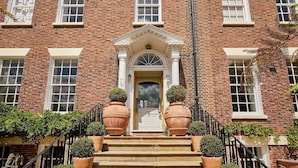 A brick building with a central entrance, large windows, and a staircase leading up to the door. - Host Stay The Nest Whitby (Whitby)