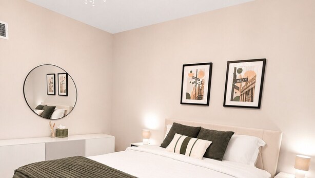 A neatly arranged bedroom with a bed, bedside tables, a mirror, and wall art. - NYC Bus at Door • EWR • Outlet • MetLife • Parking - 3-bedroom apart, 1st floor. (Elizabeth)