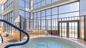 A spa area with a hot tub, a pool, and a view of the beach. - Phoenix II 2065 by Liquid Life (Orange Beach)