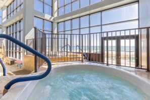 A spa area with a hot tub, a pool, and a view of the beach. - Phoenix II 2065 by Liquid Life (Orange Beach)