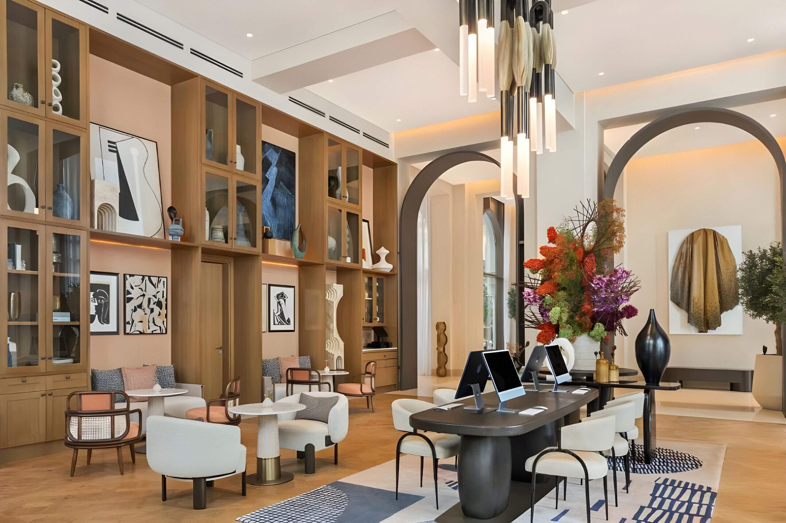 A modern interior with open shelving, a dining area, and a reception desk.