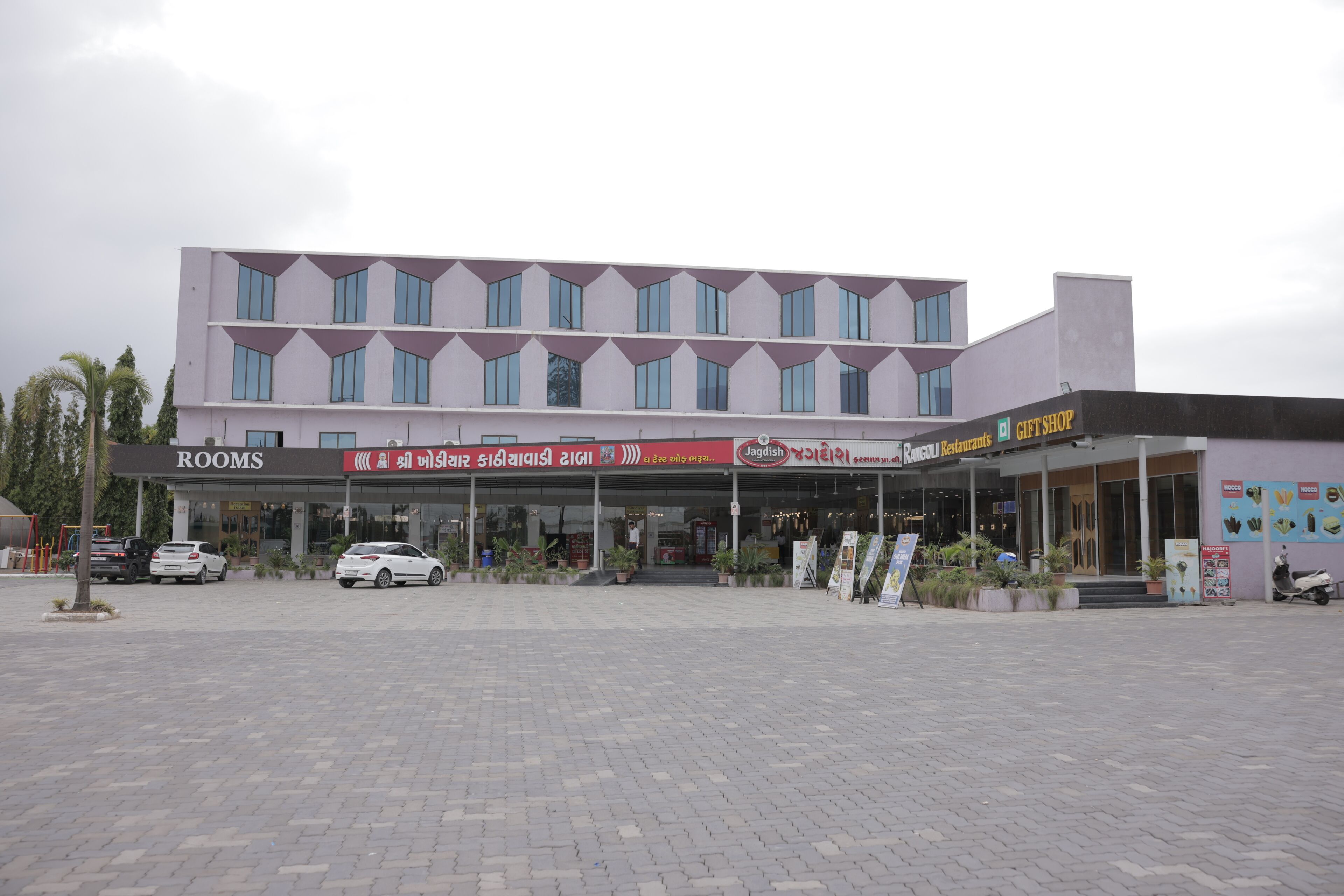 A hotel with a modern facade, multiple floors, and a ground-level restaurant.