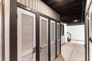 A row of closed doors with numbers 343 and 344, leading to a staircase. - Basecamp to All Things Northern Michigan (Boyne Falls)