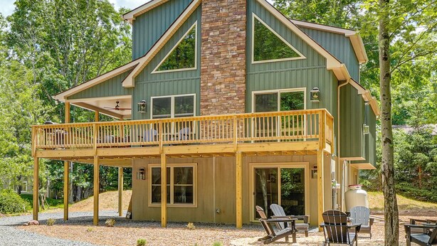 A two-story house with a balcony, large windows, and a stone chimney. - 1 Mi to Beach! Home w/ Game Room in Albrightsville (Albrightsville)