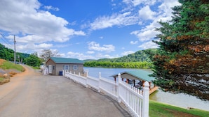 A lakeside property with a house, a dock, and a white fence. - Waterfront Deck w/ Mtn View! Claytor Lake Retreat (Draper)