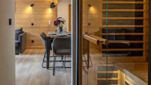 A modern interior with a dining area, a sofa, and a staircase. - Cozy apartment - 6 guests, near slopes (Belle Plagne)