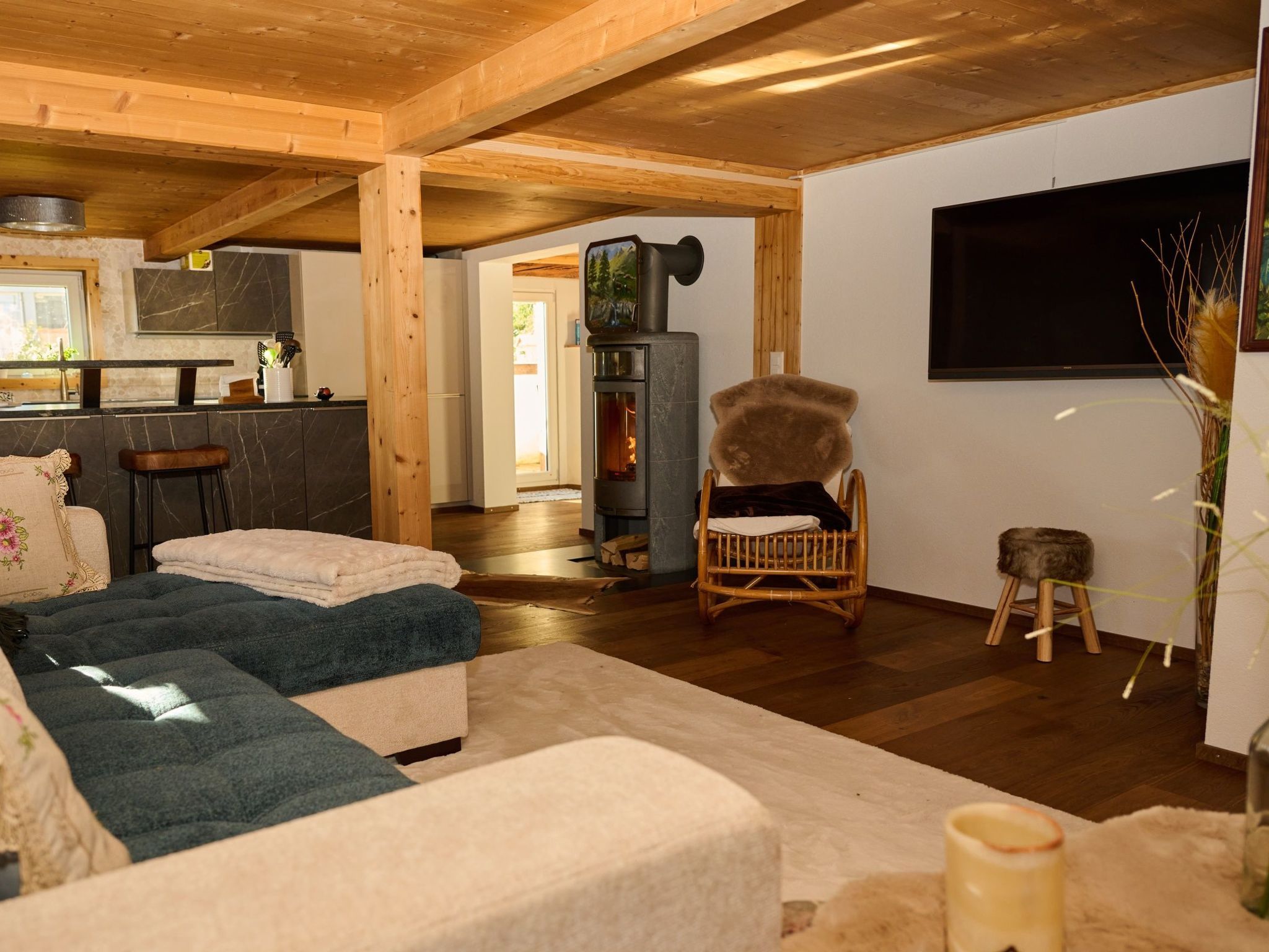 A cozy living room with a fireplace, a television mounted on the wall, and a comfortable seating area.