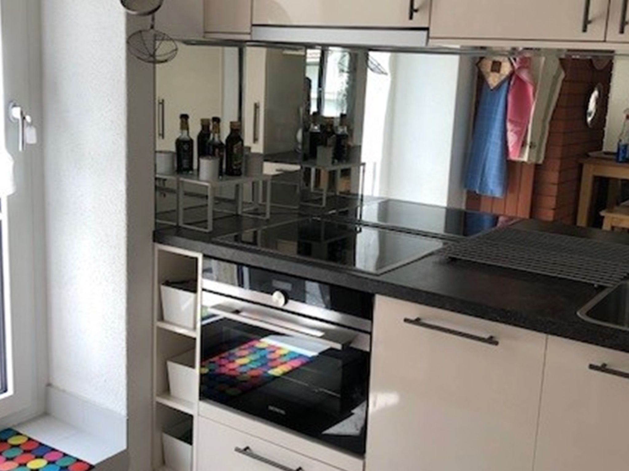 A kitchen with a countertop, a built-in oven, and a storage drawer.