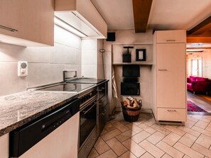 A modern kitchen with a built-in dishwasher, oven, and a large countertop.