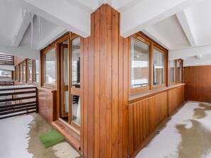 A room with wooden paneling, large windows, and a sloped ceiling. - Spacious apartment, panoramic view - 6 guests (La Plagne)