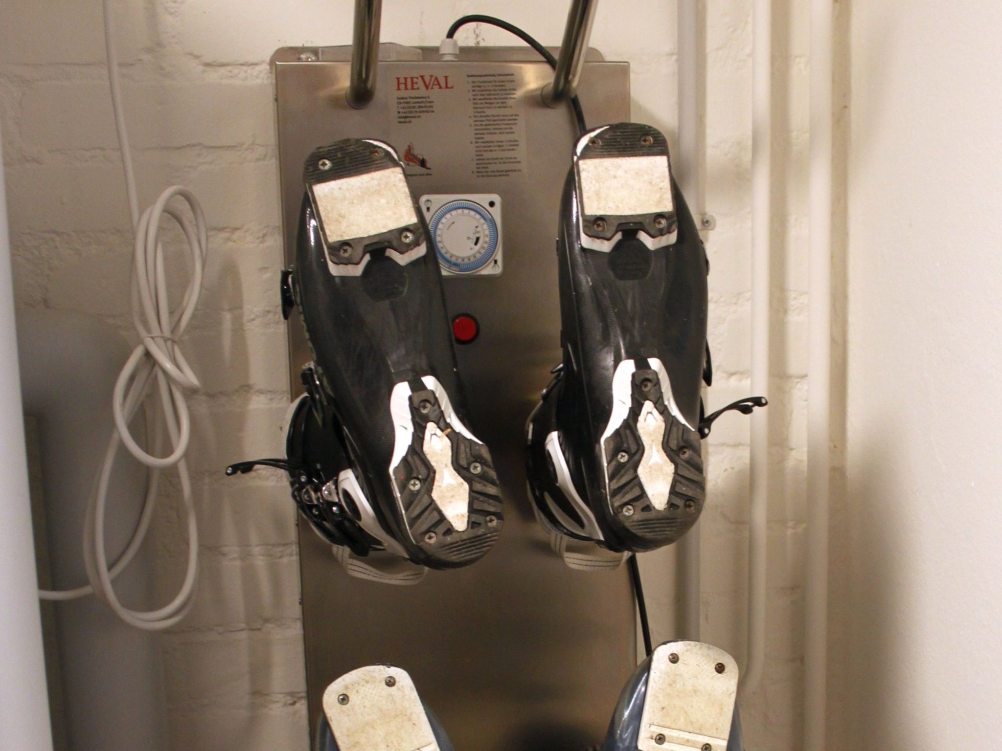 A control panel with two foot pedals, a gauge, and a red button.