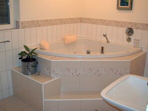 A bathroom with a freestanding bathtub, a sink, and a potted plant. - Egglisboden, (Quarten), by Interhome (Mols)