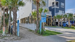 A beachfront property with a 'Surf Area' sign, a 'Pay to Park' sign, and a 'Parking Only' sign. - Seven C's - Five Bedroom Five & a Half Bath Third Row Home with Private Pool (Surfside Beach)