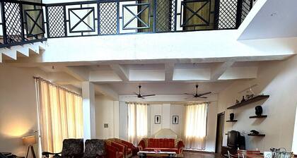 Luxury 4BR hill villa with lawn, fireplace, foosball & mountain views.