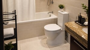 A modern bathroom with a bathtub, toilet, and shower. - Luxury Downtown Skyline Suite Burj Khalifa View (Dubai)