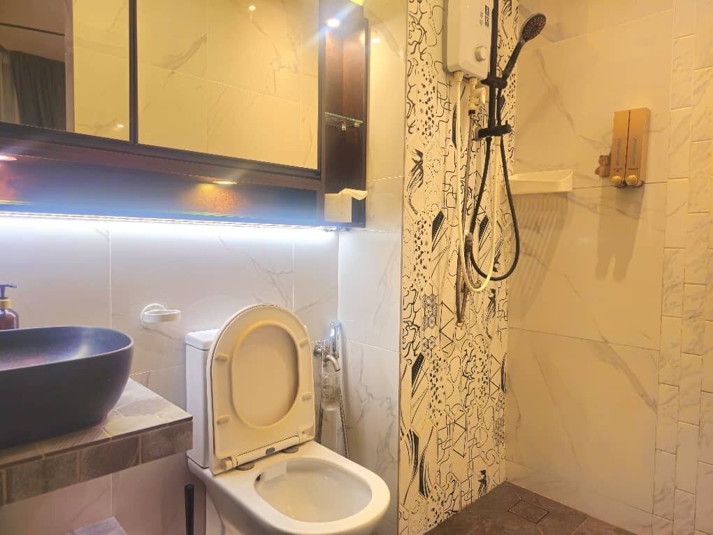 A modern bathroom with a toilet, bidet, and a large basin.