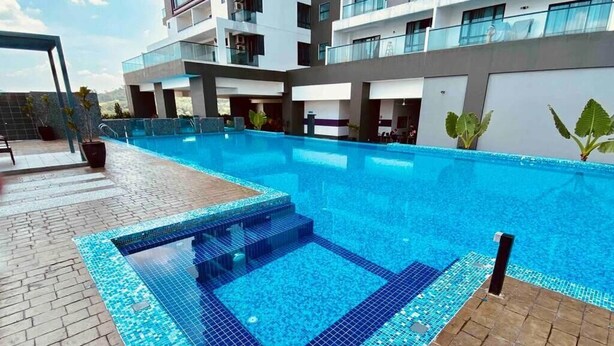 A modern hotel with a large outdoor swimming pool, a covered seating area, and a multi-story building with balconies. - Landmark Residence I Kajang I City View (Kajang)