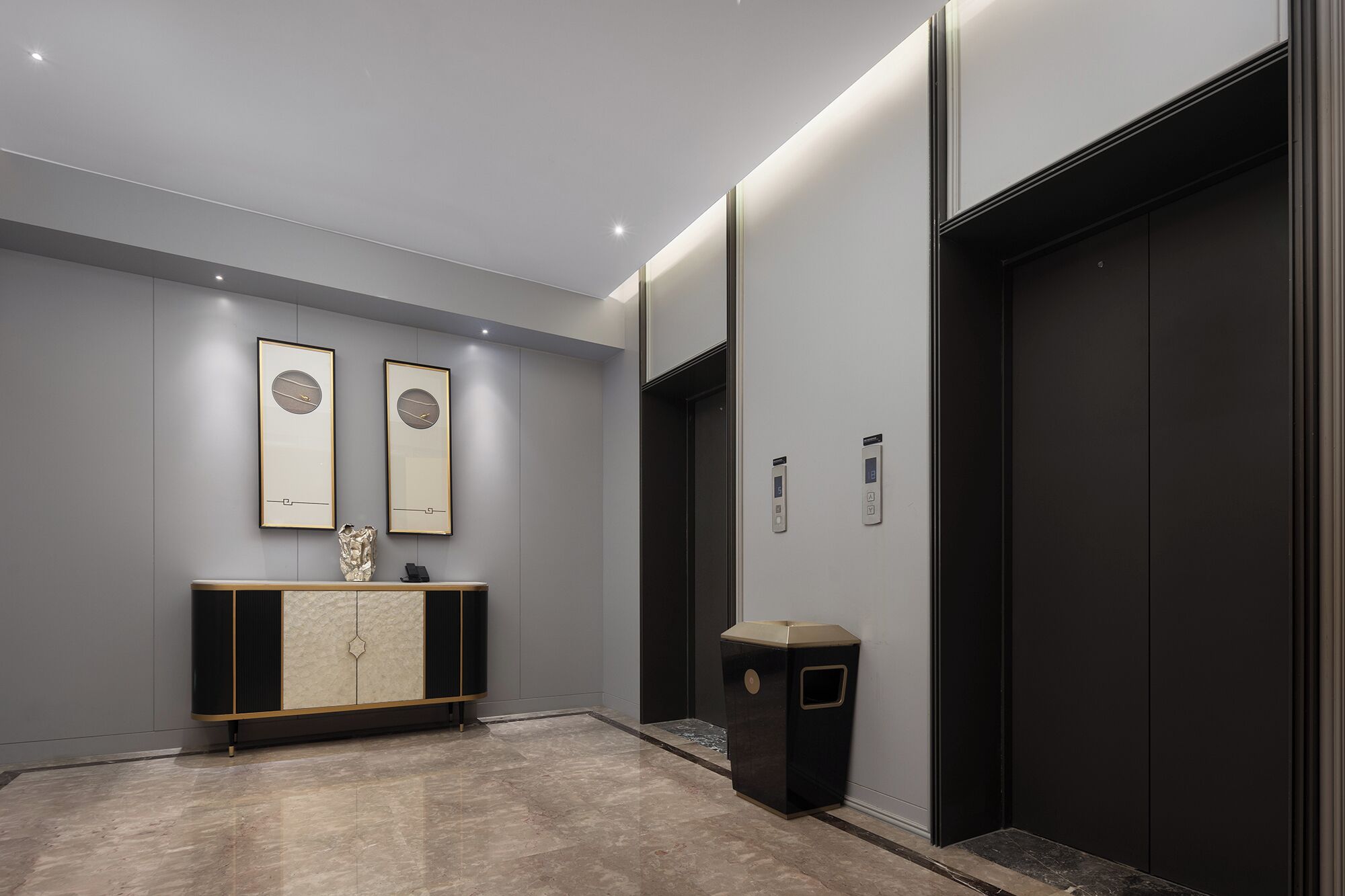 A modern elevator with a digital display, a marble floor, and a minimalist console with framed artwork.