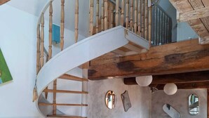 A spiral staircase with wooden balusters, a dining area with chairs and a table, and a piano. - A family home between the sea and the countryside! (Sainte-Agathe-d'Aliermont)