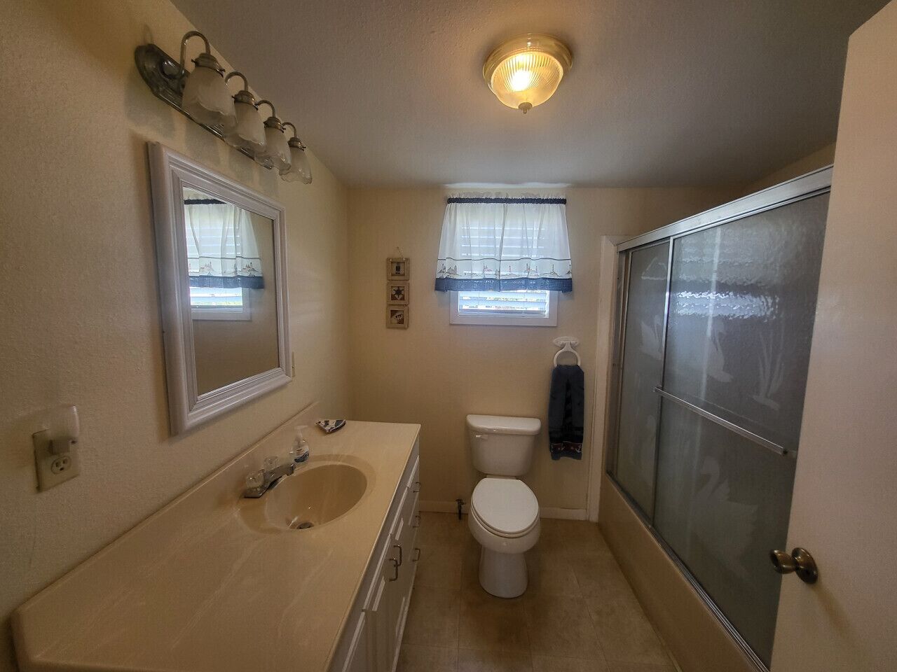 A bathroom with a sink, toilet, and shower.
