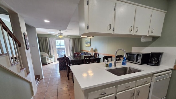 A kitchen with white cabinets, a sink, and a dishwasher. - Waterfront Condo with Private Boat Slip and Community Swimming Pool (Port O`Connor)