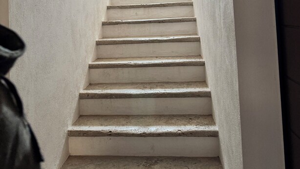 A staircase with a wooden ceiling and a small window at the top. - Cozy Tuscan apartment near Siena, ideal for groups and families (Rosia)