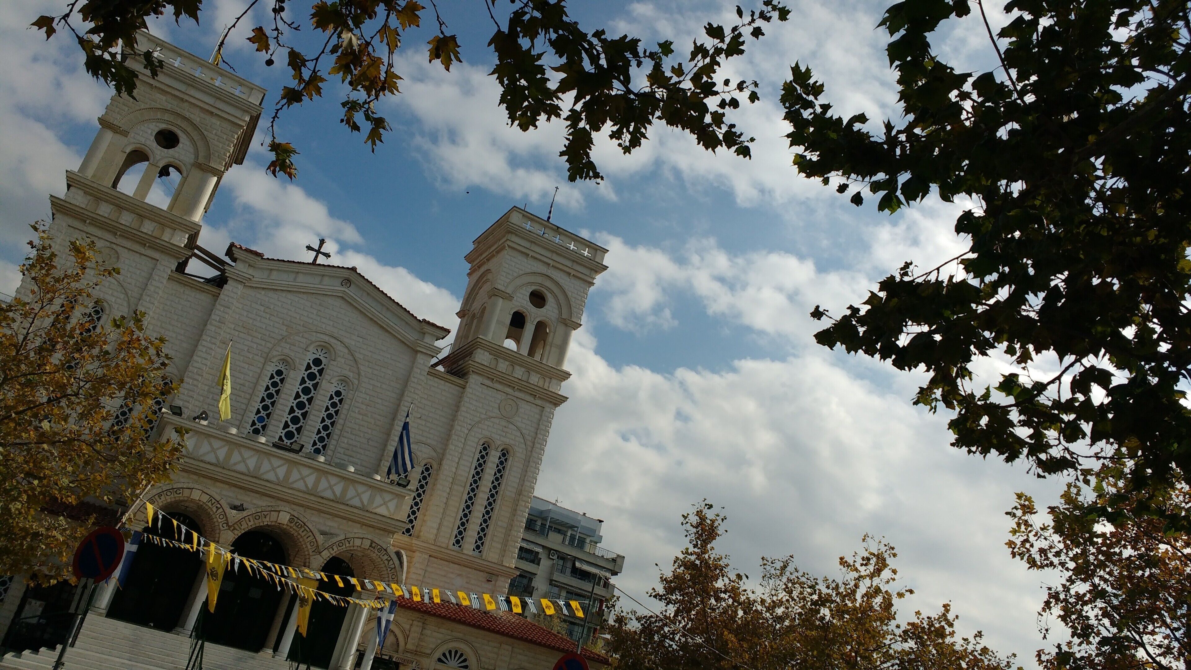 A church with two towers, a bell tower, and a large arched entrance.
