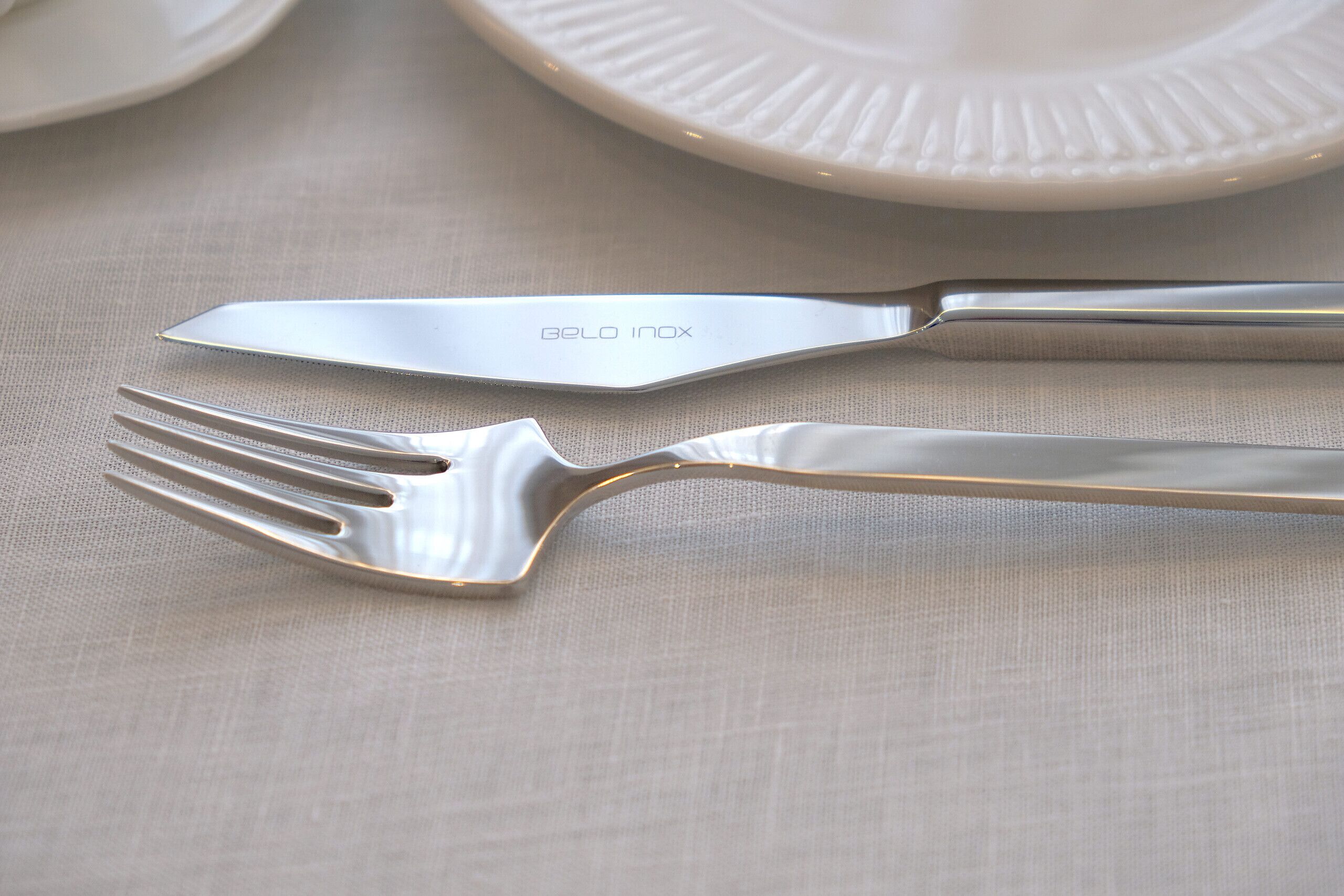 A table setting with a fork, knife, and a plate.