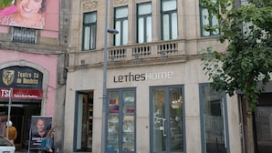 A building with a large glass storefront, a sign reading 'Lethehome,' and a visible entrance. - Letheshome Apartments 205 (Oporto)