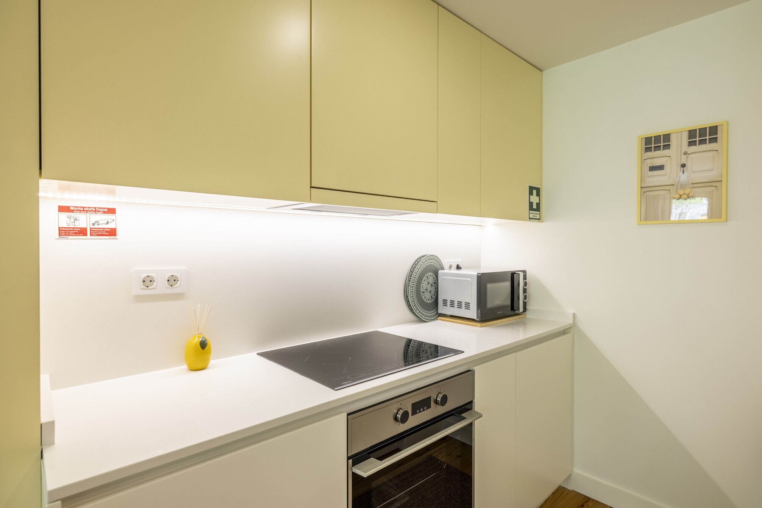 Uma cozinha com micro-ondas, torradeira e forno.
