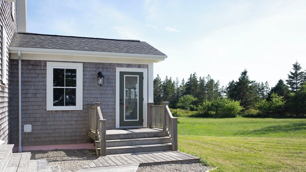 A residential building with a front porch, a door, and a window. - Modern Guest Suite with Gym & Sauna (Pubnico)