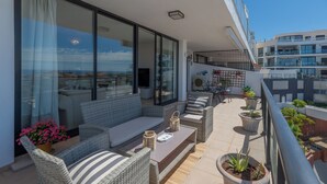 A balcony with outdoor furniture, potted plants, and a view of the cityscape. - LXR Hollywood Hills 2-Bedroom: Stunning Views (Mijas)
